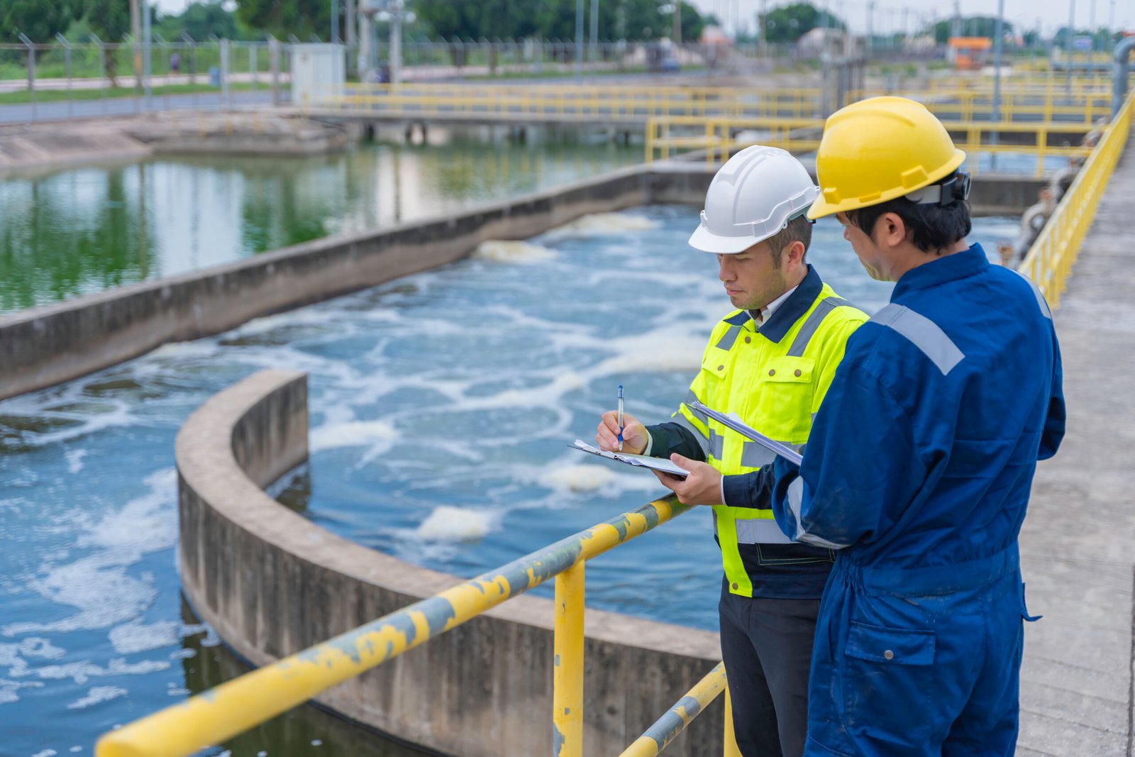 Environmental engineers work at wastewater treatment plants,Water supply engineering working at Water recycling plant for reuse,Technicians and engineers discuss work together.