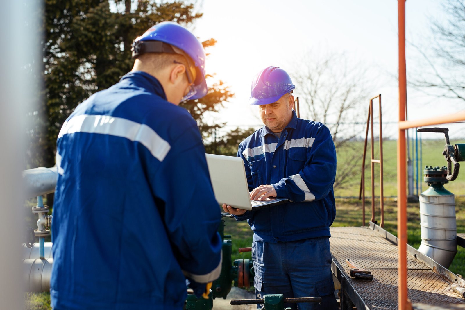 Two engineers working inside oil and gas refinery