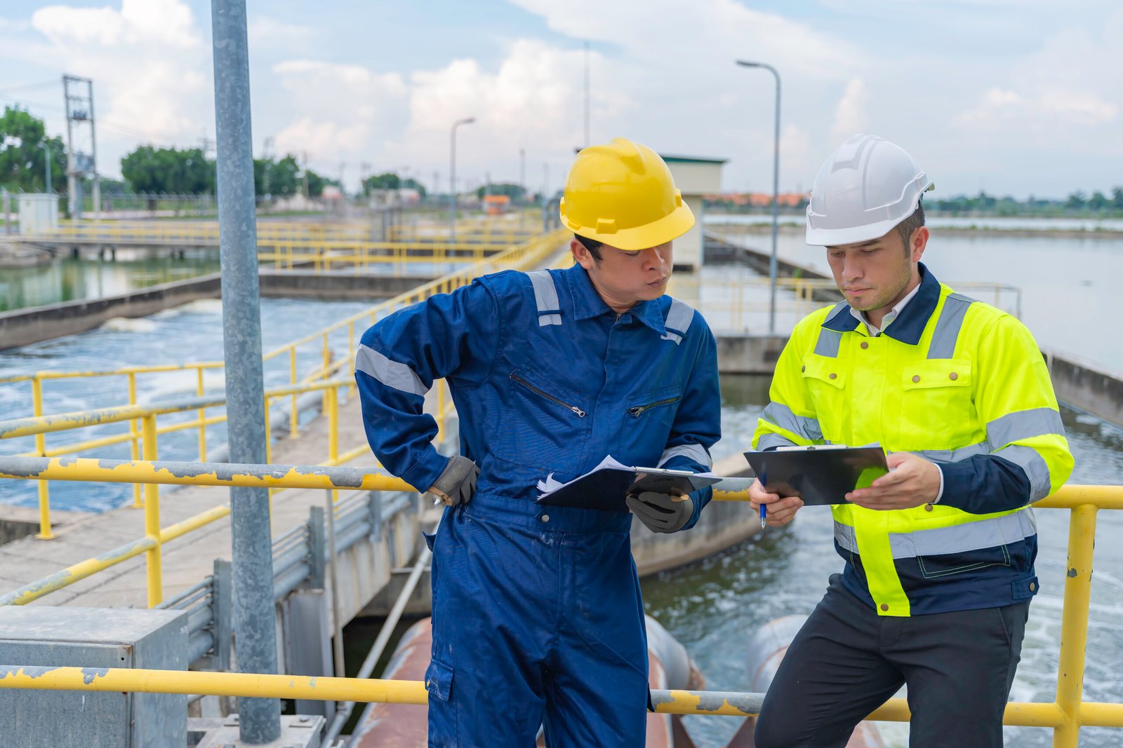 Environmental engineers work at wastewater treatment plants,Water supply engineering working at Water recycling plant for reuse,Technicians and engineers discuss work together.