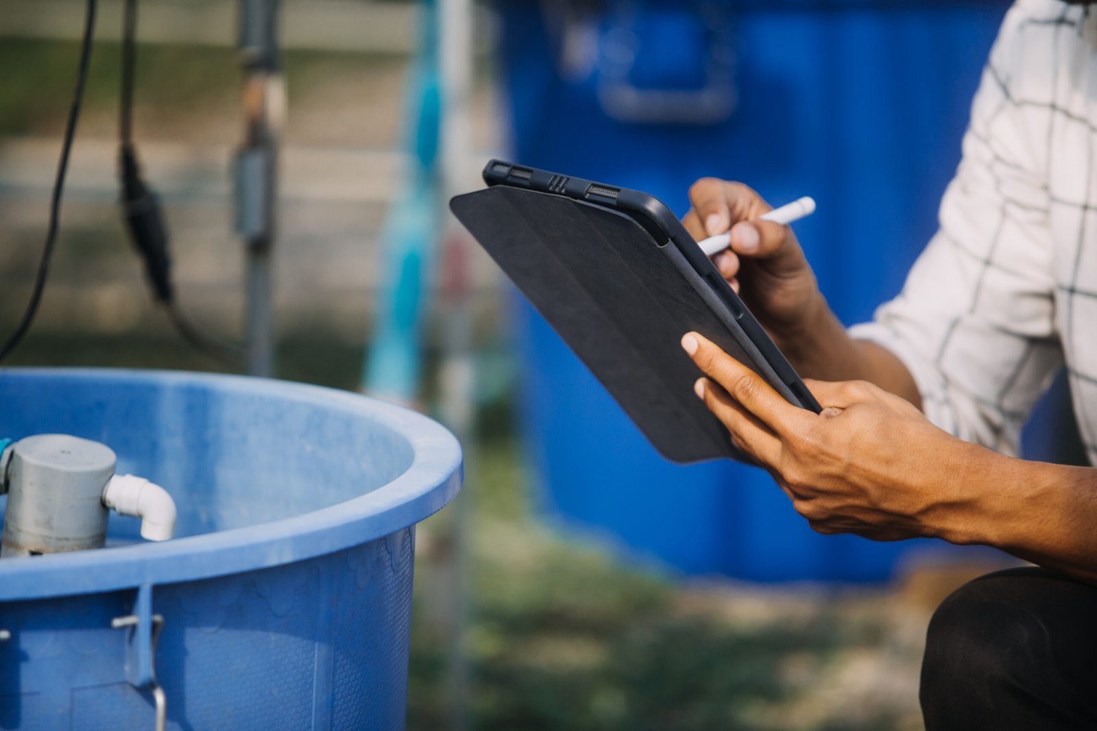 In the Industrial Greenhouse Two Agricultural Engineers Test Plants Health and Analyze Data with Tablet Computer.