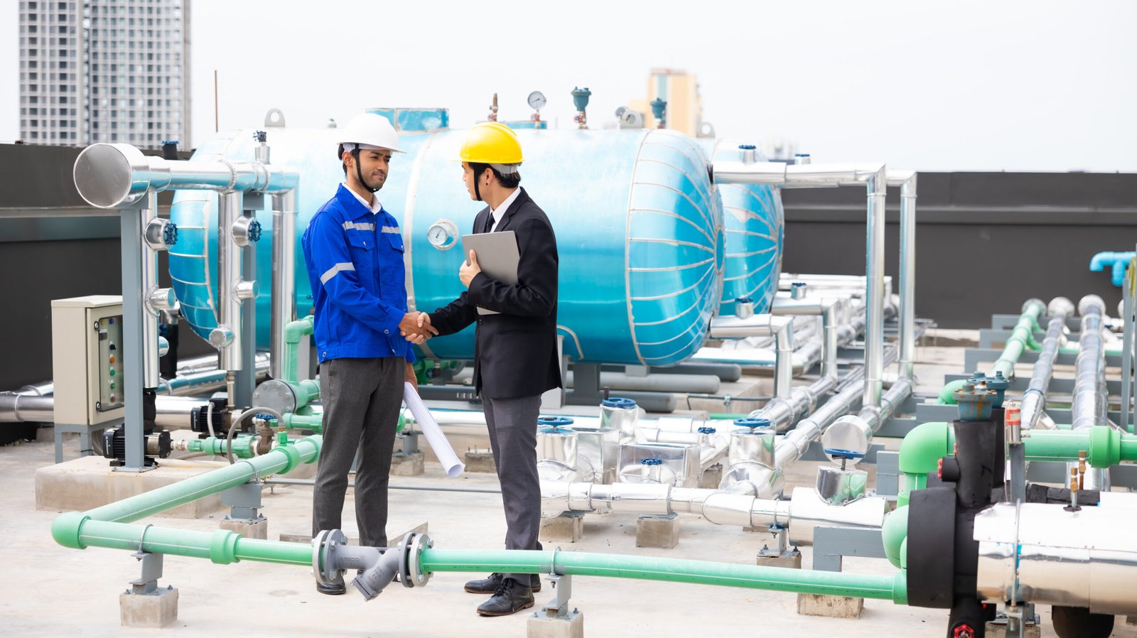 Professional team Asian business man young ceo and energy engineer plan a project to build a solar panel for the building under construction. clean and green alternative energy concept.